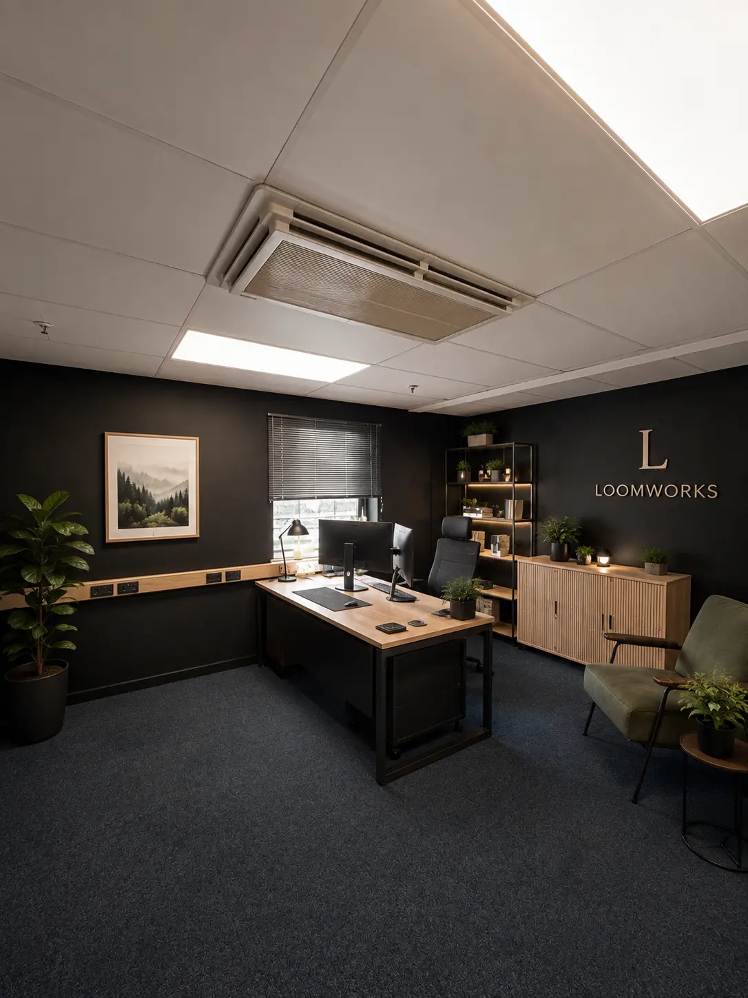 A private Loomworks office with a desk, meeting chair and planted shelving